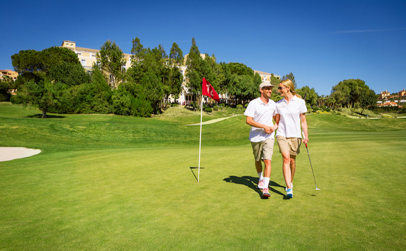 Happy couple exiting the 18th hole at Montecastillo Golf, Spain