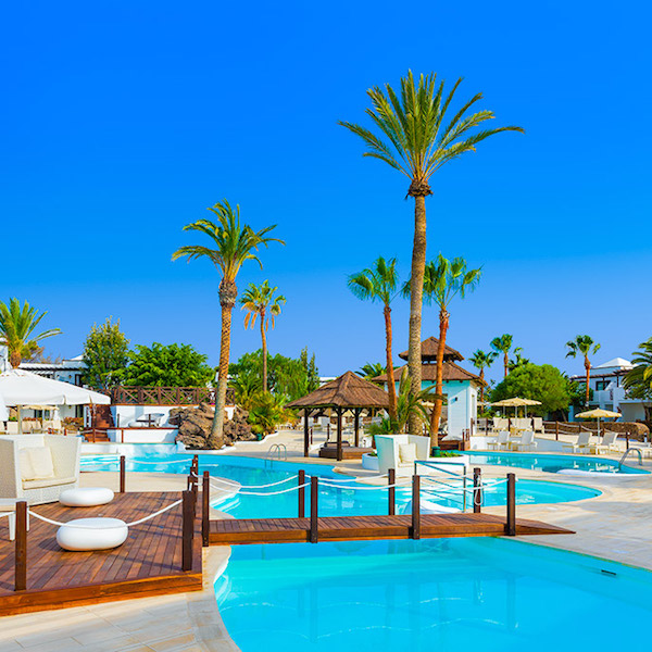 Pools and palm trees at H10 Sentido White Suites Hotel